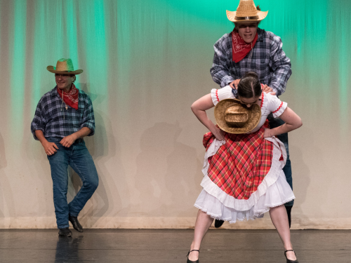 A gif of Roman jumping over a girl as part of the Canadiana dance 'Country'