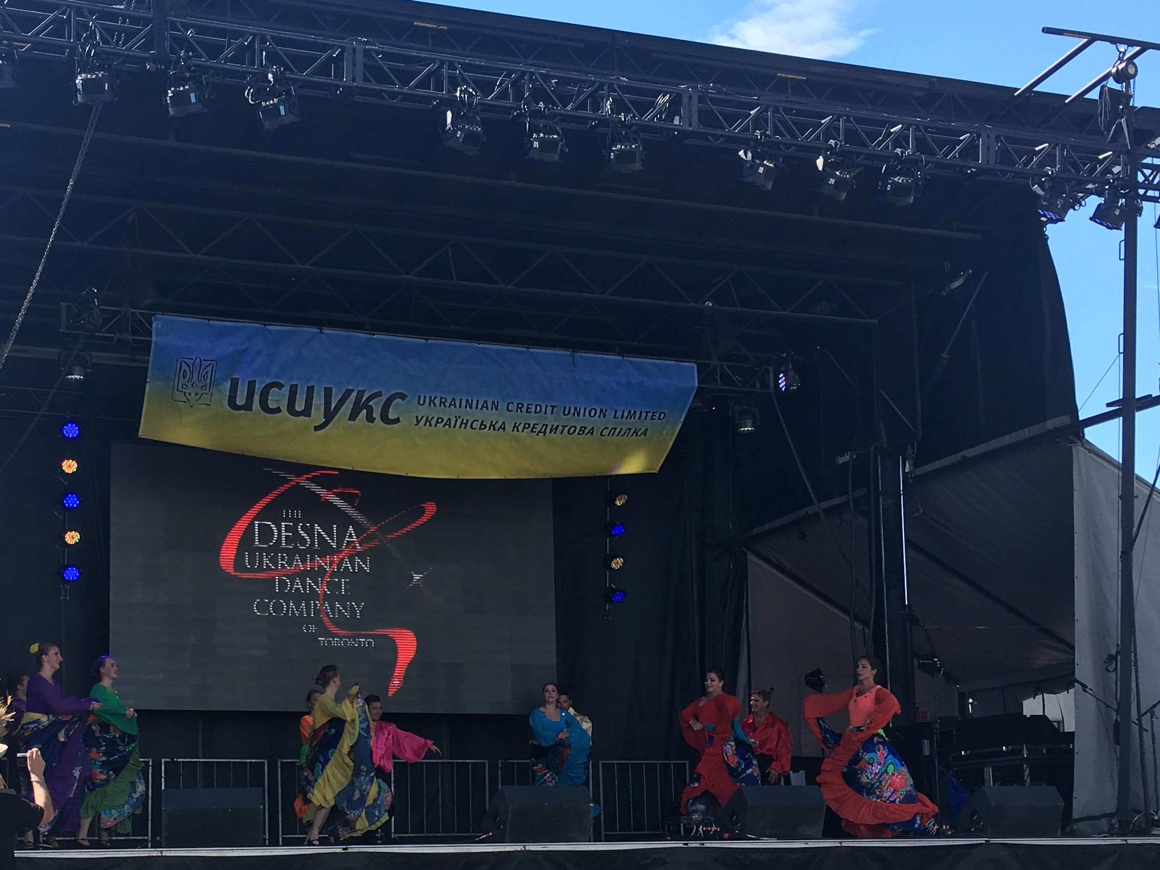 Girls in bright long dresses are filling up the stage.