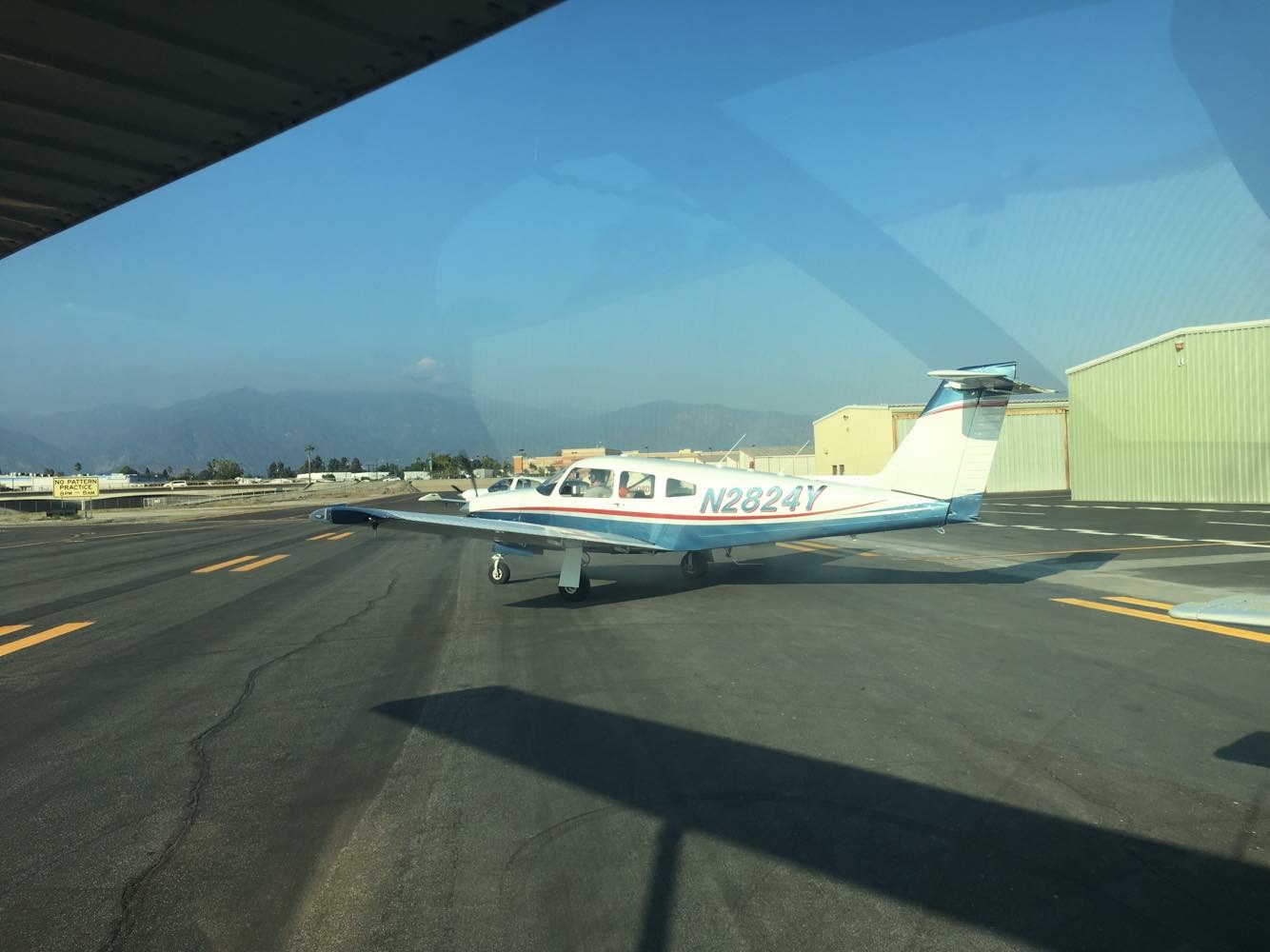 A picture of a small plane taken from inside another plane
