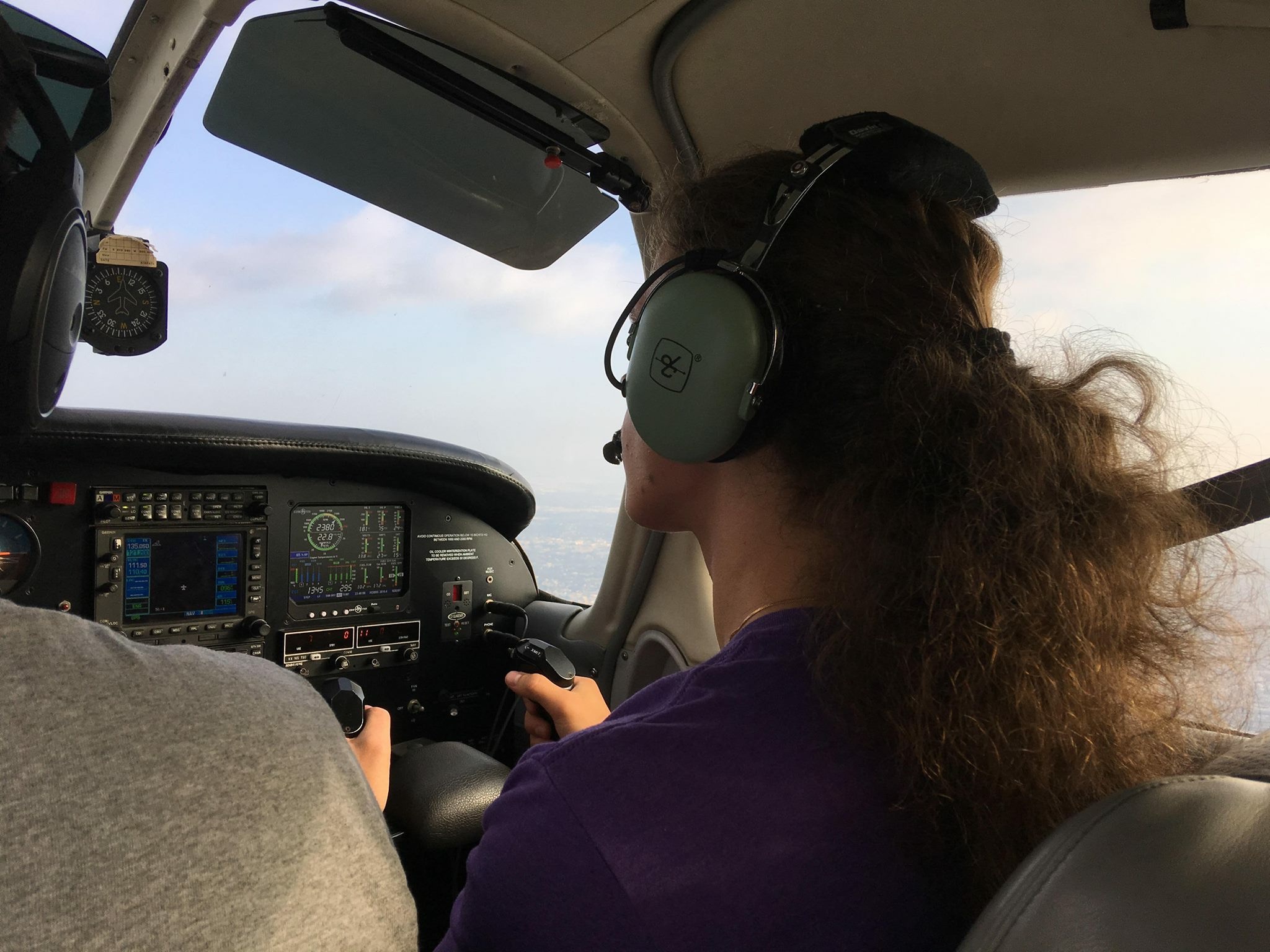 Roman in the co-pilot seat experiencing the feeling of flying a small plane.