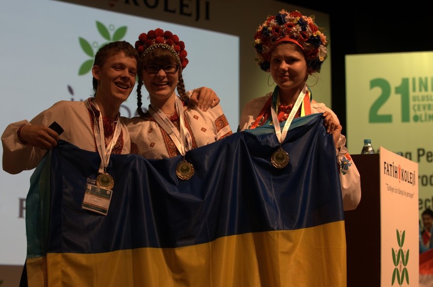 Roman Korol, Iryna Repetylo and Daria Borovlova holding the Ukrainian flag and wearing their medals after the awards ceremony at the International Ecology Project Olympiad (INEPO-2013) in Istanbul, Turkey
